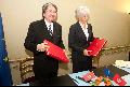 Mr Tsang and Mrs Lagarde exchange documents after signing the agreement for the avoidance of double taxation.