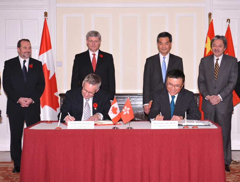  Hong Kong entered into an agreement with Canada today (November 11) for the avoidance of double taxation and the prevention of fiscal evasion with respect to taxes on income. Photo shows the Chief Executive, Mr C Y Leung (back row, second right), and the Prime Minister of Canada, Mr Stephen Harper (back row, second left), witnessing the signing of the agreement by the Secretary for Financial Services and the Treasury, Professor K C Chan (front row, right), and the Canadian Minister of International Trade and Minister for the Asia-Pacific Gateway, Mr Edward Fast (front row, left).