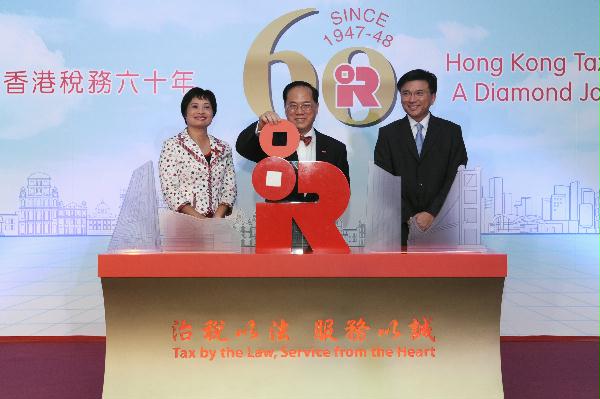 The Chief Executive, Mr Donald Tsang, officiates at the opening ceremony of the Inland Revenue Department's 60th anniversary exhibition today (October 23). With him are the Secretary for Financial Services and the Treasury, Professor K C Chan and the Commissioner of Inland Revenue, Mrs Alice Lau.