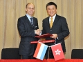 Professor Chan and Mr Luc Frieden exchange documents after signing the Protocol to the comprehensive agreement on avoidance of double taxation.