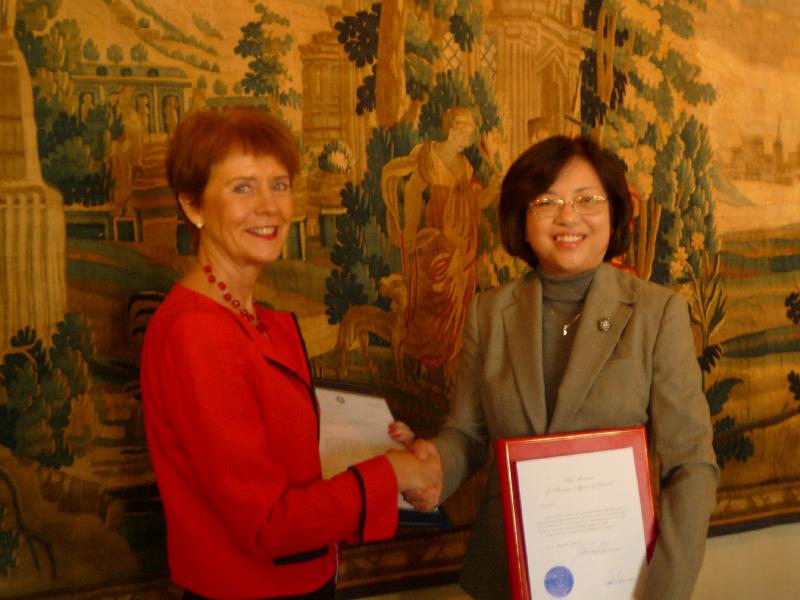 Ms Lai (right) shakes hands with Ms Berglind Ásgeirsdóttir after signing the agreement.
