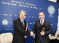 Mr Tsang (left) and Mr Attila György (right) exchange documents after signing the agreement